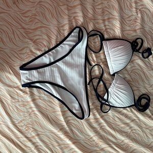 Bikini sold by H&M, top size 4, bottom size 2. white base, navy blue outline.